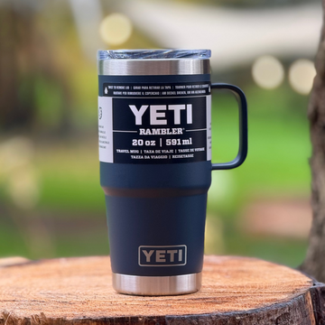 YETI Rambler mug on a wooden surface with a blurred natural background