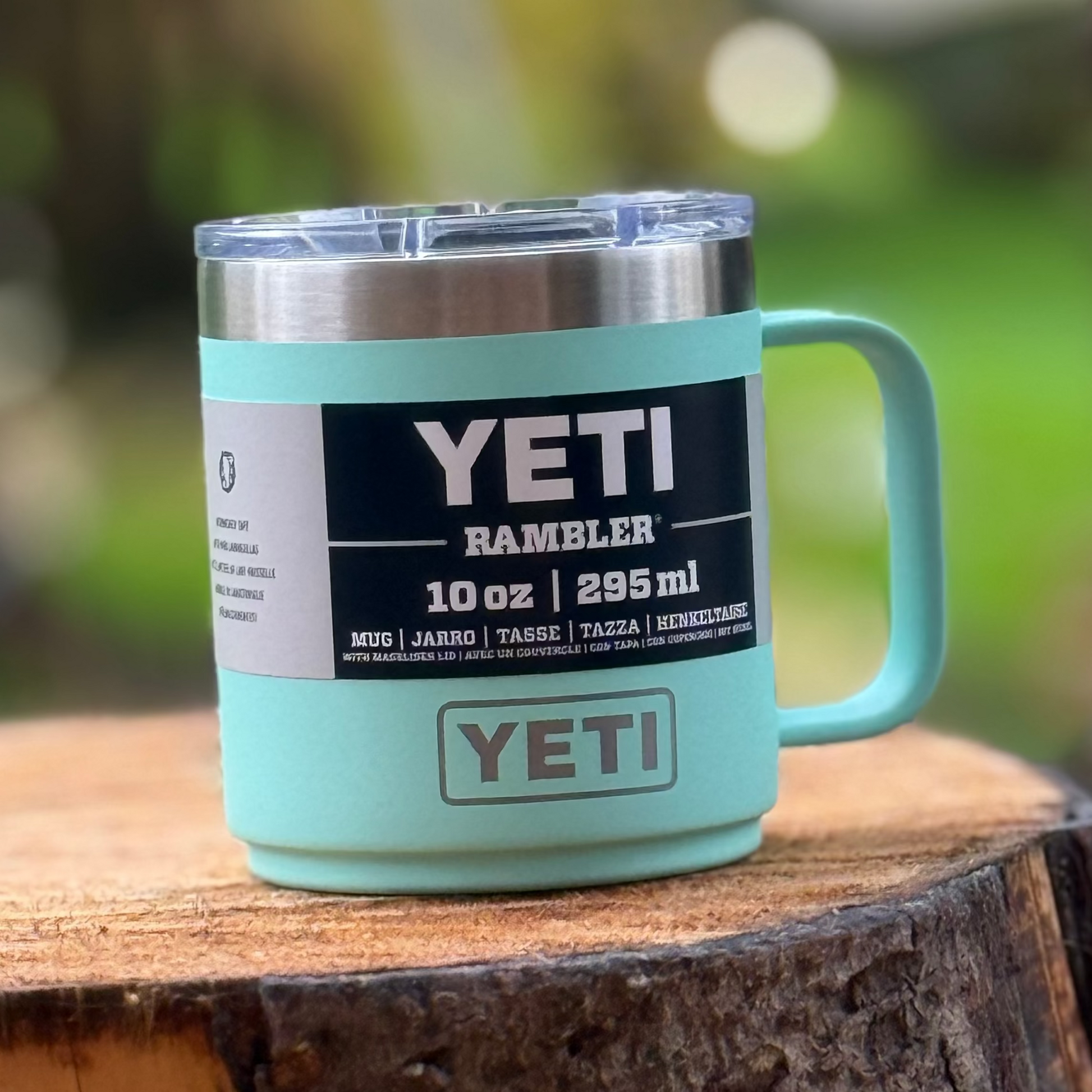 YETI mug on a wooden surface with a blurred green background